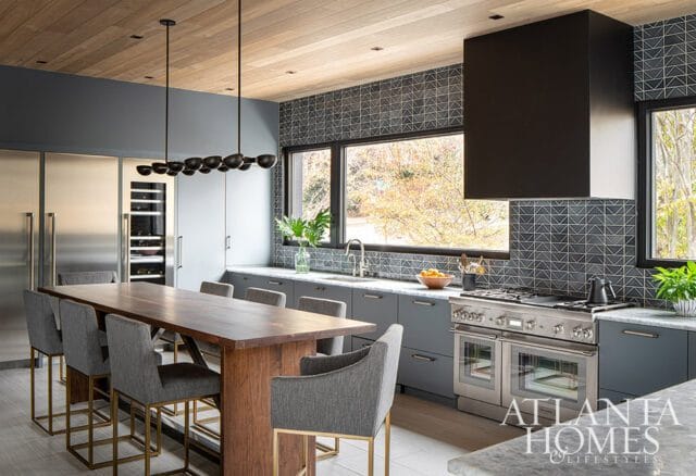 Modern gray kitchen with wood ceiling, large island, stainless steel appliances, and geometric