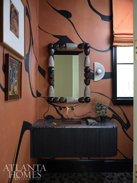 Powder room with terracotta walls, black abstract pattern, fluted black vanity, marble countertop