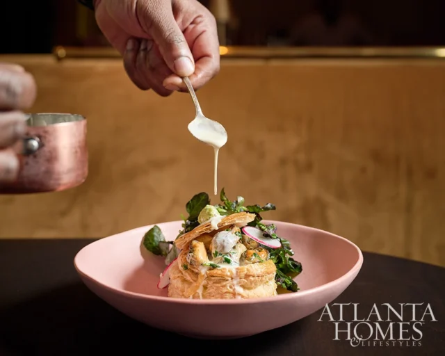 Atlanta Homes & Lifestyles logo on a pink bowl with a pastry dish