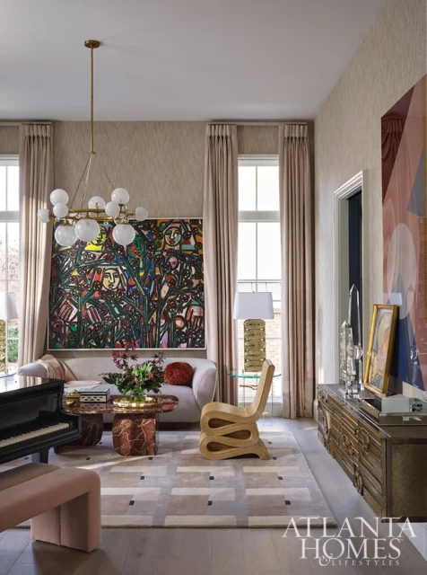 Living room with abstract art, modern furniture, and a piano.