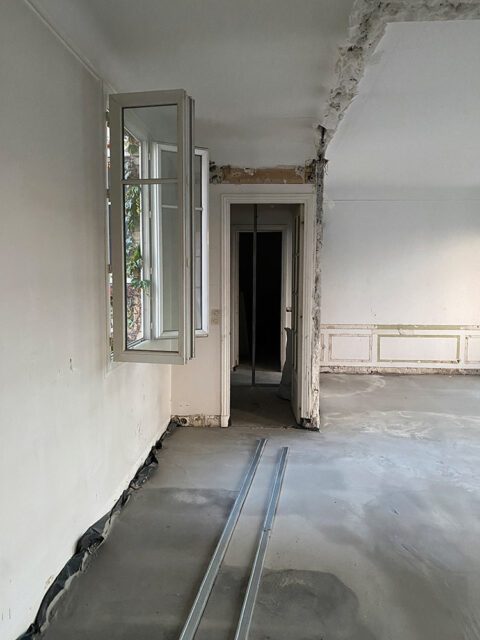 Interior under renovation with exposed ceiling, unfinished walls, and concrete floor.