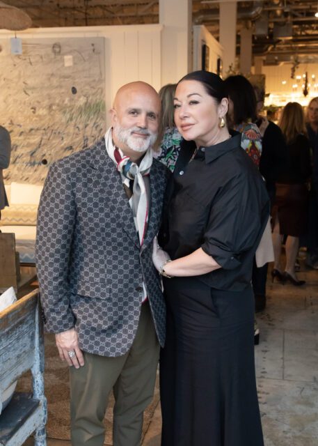Man in patterned jacket and woman in black shirt and skirt