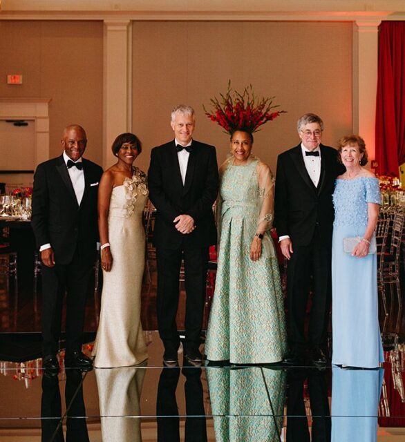 Six people in formal attire posing for a photo.