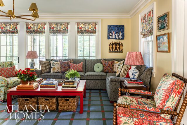 Living room with patterned upholstery, red coffee table, and sectional sofa.