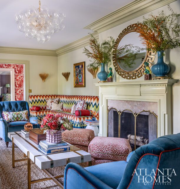 Living room with chevron banquette, blue velvet chairs, and leopard print ottomans