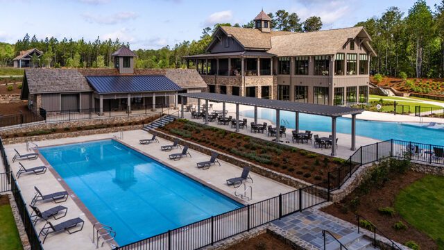 The Benjamin lakeside pool complex with lounge chairs and covered seating area.