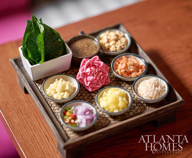 Tray with ingredients for miang kham: betel leaves, peanuts, dried shrimp, shredded coconut