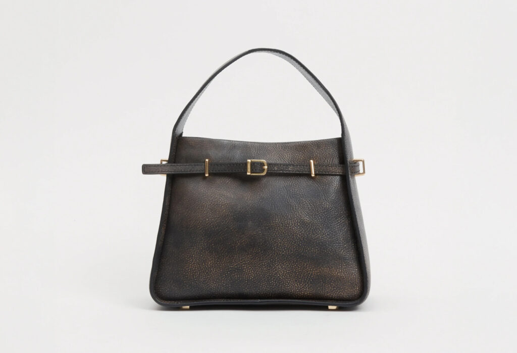 Black leather handbag with gold buckle and strap detail