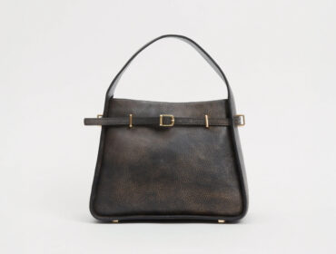 Black leather handbag with gold buckle and strap detail