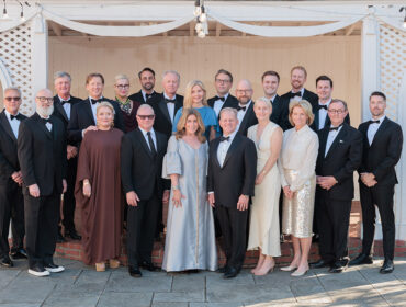Group of people in formal attire posing for a photo.