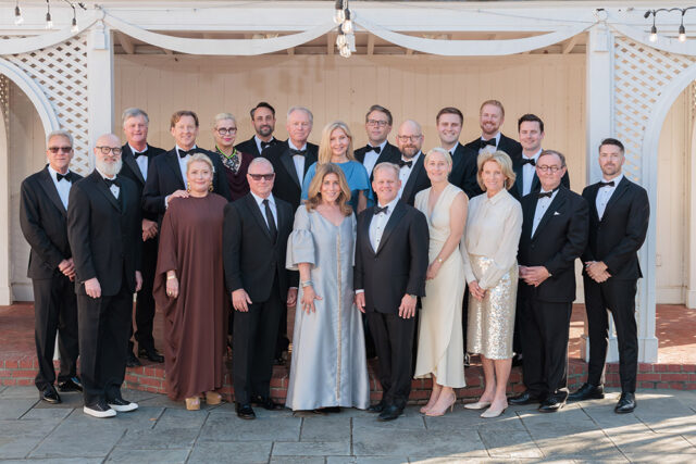 Group of people in formal attire posing for a photo.