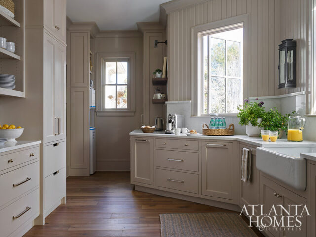 Neutral kitchen with shaker cabinets, marble countertops, and apron sink. Atlanta Homes &