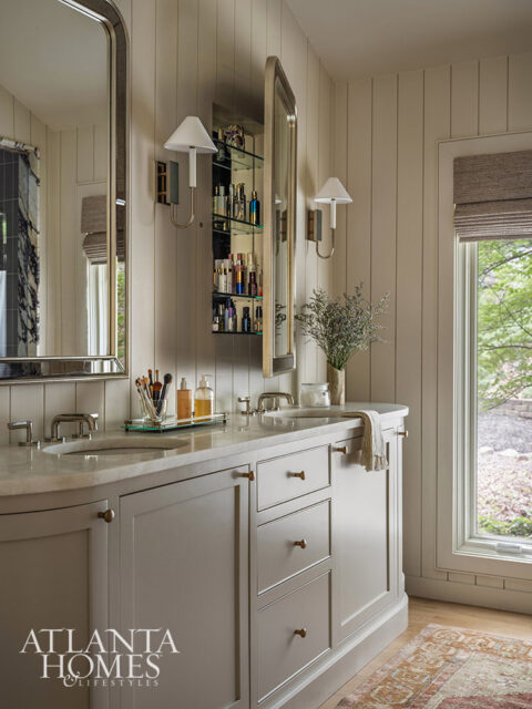 Gray double vanity with marble countertop, brass hardware, and built-in medicine cabinet.