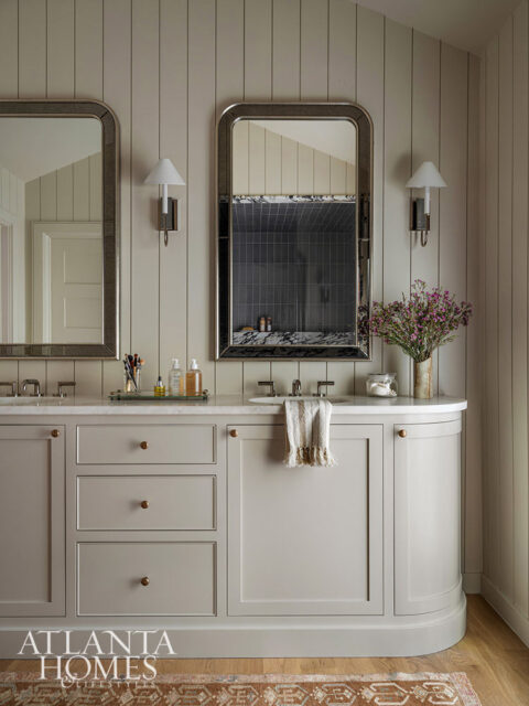 Although they appear to be doors, the curving side cabinets are actually spacious drawers—a favorite detail of the designer.