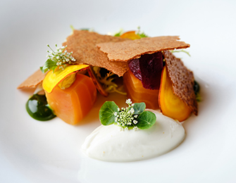 Beetroot and citrus dessert with white cream and herbs.