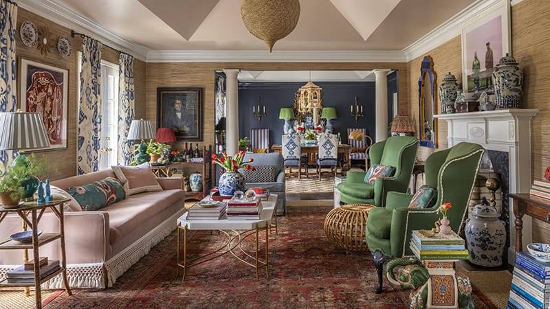 Living room with patterned wallpaper, blue and green accents, and a decorative lantern.